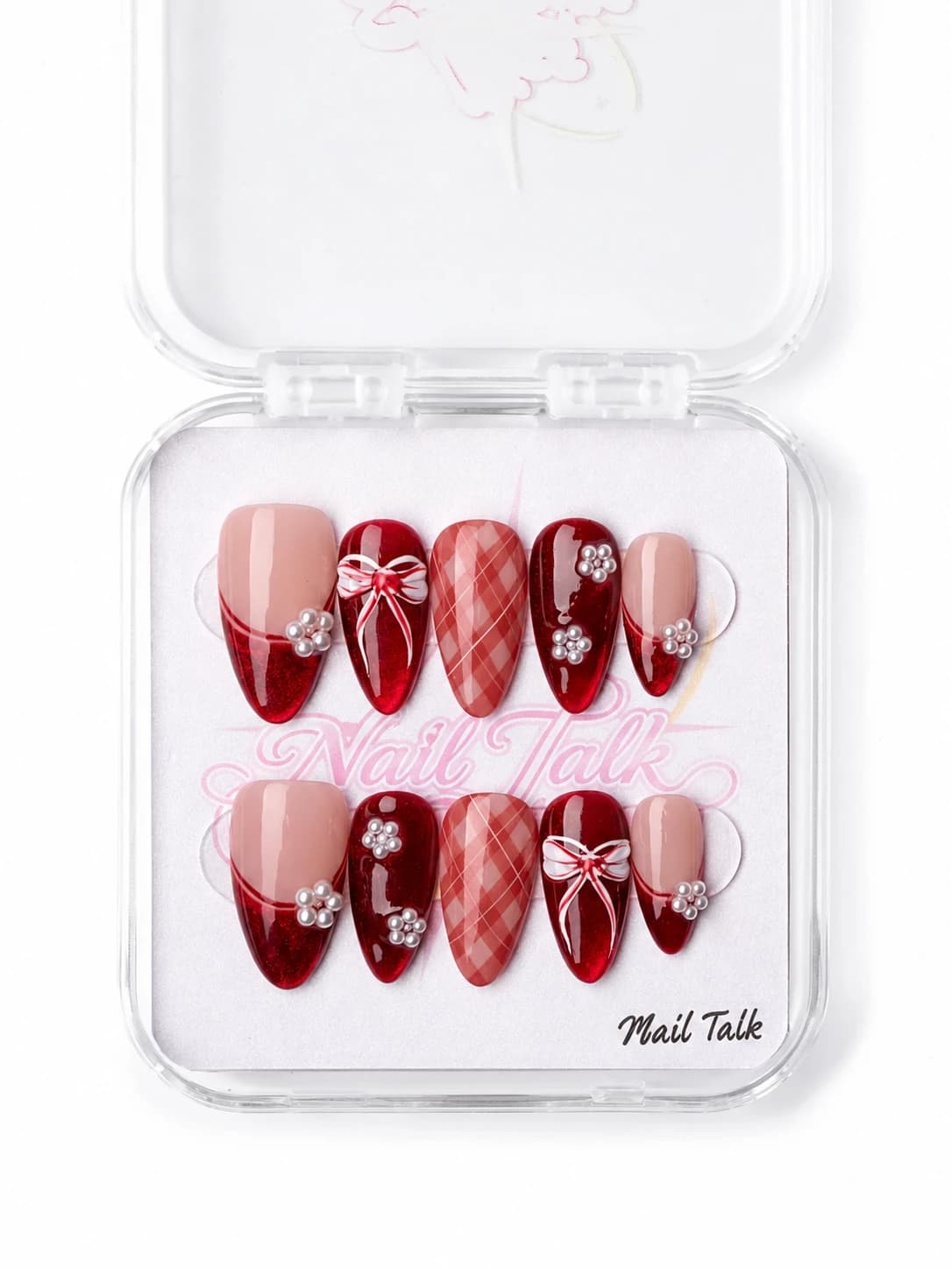 Deep red press-on nails with pearl flowers, a white bow and pink plaid